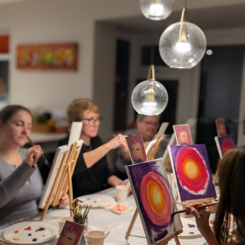 Children painting a mandala canvas